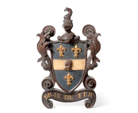 A Victorian Carved and Painted Oak Armorial, surmounted by a bird and helmet crest, the shield flanked by acanthus leaves ove