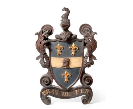 A Victorian Carved and Painted Oak Armorial, surmounted by a bird and helmet crest, the shield flanked by acanthus leaves ove