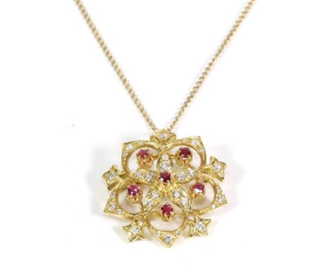 A Ruby and Diamond Brooch/Pendant, on Chain, a flower shaped pendant set with six round cut rubies in claw settings, to a pie
