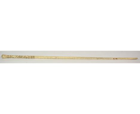 A Whalebone Walking Stick, mid 19th century, the handle carved with flowerheads and strapwork, 89cm long