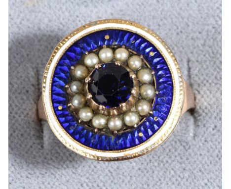 A Blue Spinel, Seed Pearl and Enamel Ring, a round cut blue spinel in a collet setting within a border of seed pearls to a bl