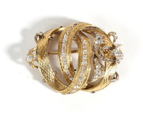 A Diamond Brooch, two interlocked hoops with applied scroll detail set throughout with old cut diamonds, total estimated diam