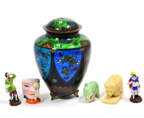 A Japanese Cloisonné Enamel Ovoid Jar and Cover, Meiji period, on three feet, with lappet shaped panels of foliage, 13cm high