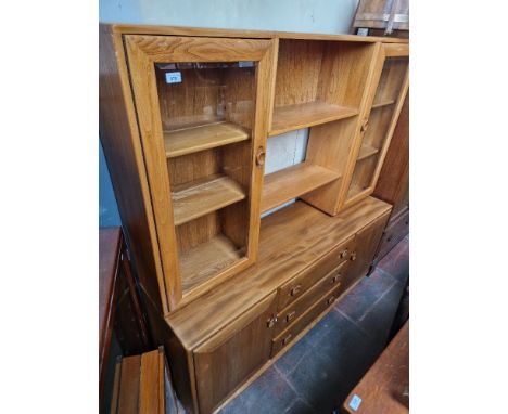 An Ercol sideboard.Condition:- General wear throughout, a split to one edge & some rough marks as per extra pictures, no sign