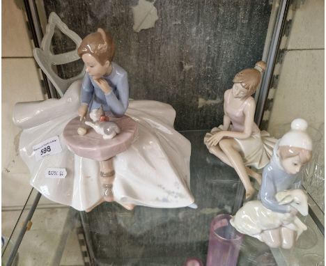 Two Nao figures of a ballerina and lady with kitten and a small Lladro figure of a child with lambThe middle finger of the ba