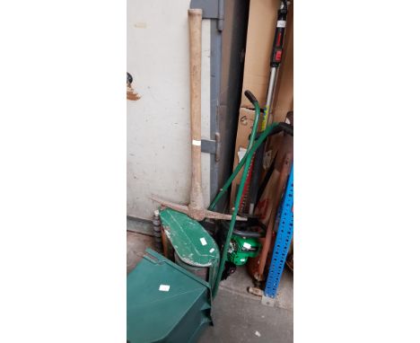 A collection of garden items including Kawasaki petrol long reach hedge trimmer, petrol hedge trimmer, push mower, pick axe, 