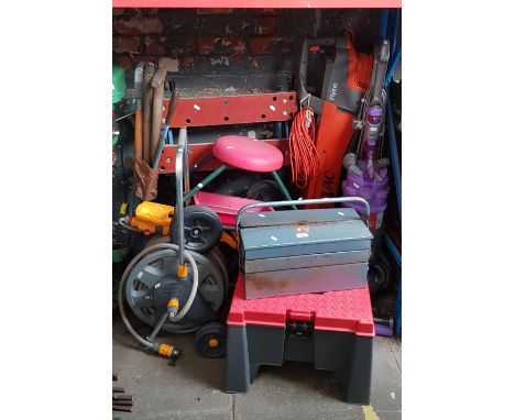 A Dyson vac, Flymo vac blower, workbench, 2 garden hose reels, metal toolbox, plastic seat/toolbox, bundle of garden tools, g