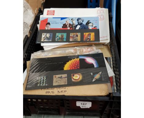 A tray containing envelopes of stamps and first day covers along with sports books and programmes 