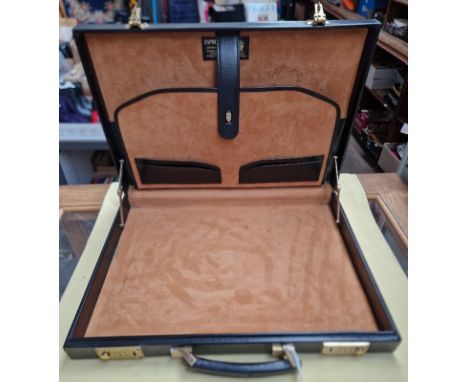 A black leather Hilton Collection executive case by Papworth Industries (Swaine Adeney Brigg), with brass combi locks and tra