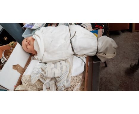 A box of vintage clothing and a doll