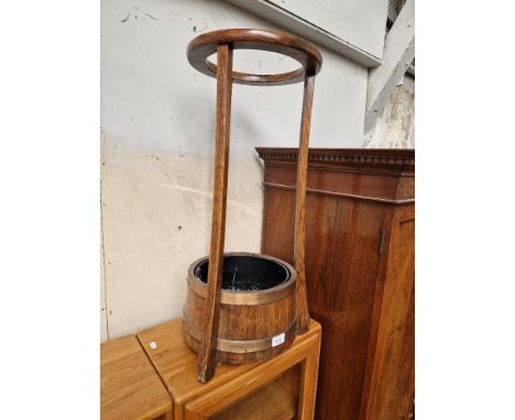 An Arts &amp; Crafts brass bound oak stick stand by Lister. 