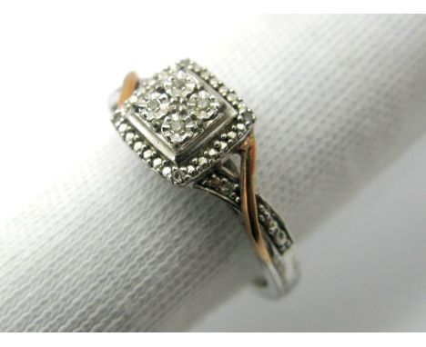 A Diamond Set Dress Ring, of cushion shape between crossover shoulders, stamped "925 375 DJA".