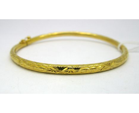 A Hinged Bangle, bright cut engraved, hinged to snap clasp, indistinctly stamped "916(?)".