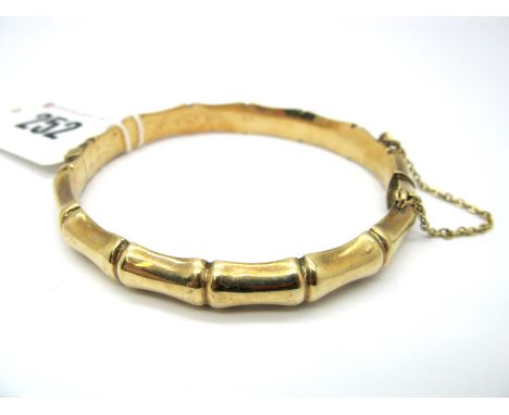 A 9ct Gold Bangle, of bamboo design, hinged to snap clasp.