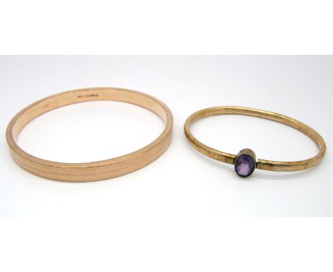 A 9ct Gold Upper Arm Bangle, engine turned, Chester 1924; together with another bangle, oval collet set to the front. (2) 
