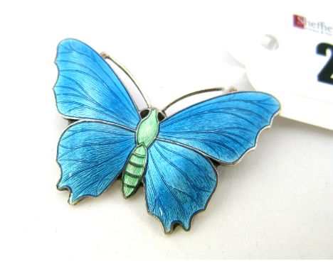 A JA&S Enamel Butterfly Brooch, highlighted in turquoise.