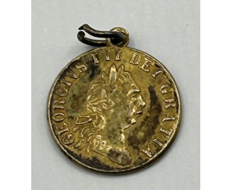 A gold plated token dated 1911, with mount cut, an&nbsp;Art Nouveau gilt metal and enamel buckle, decorated flowers, 8 cm wid