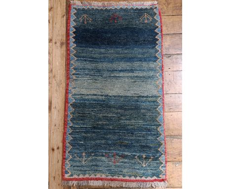 A tribal blue ground rug, 160 x 86 cm