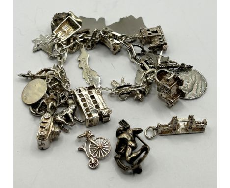 A mid 20th century silver brooch, in the form of a man and a vase, Friedrich Busse, in original box, a silver charm bracelet 