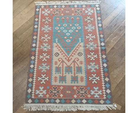 A tribal cream ground carpet, 206 x 132 cm