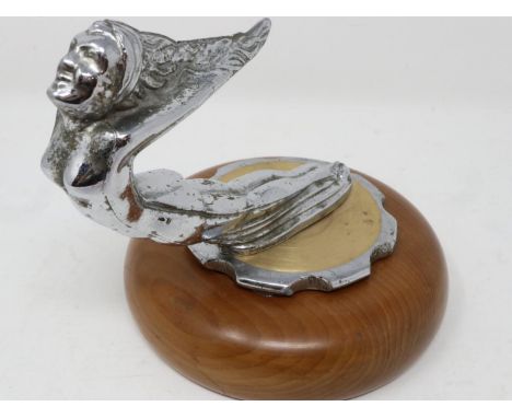 Nude chrome car mascot on a circular wooden base, H: 15 cm. UK P&amp;P Group 1 (£16+VAT for the first lot and £2+VAT for subs