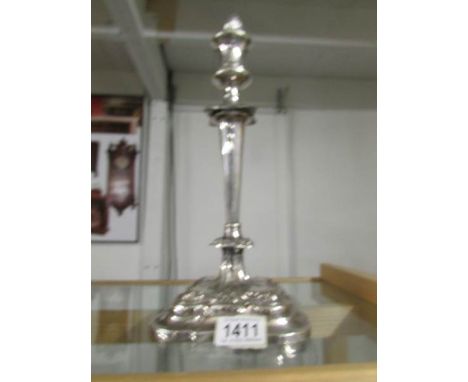 A silver plate on copper candlestick with snuffer.