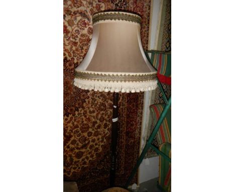 A mahogany standard lamp.