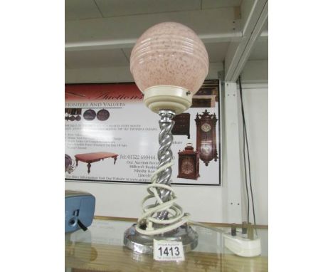 An art deco chrome barley twist lamp with pink shade.