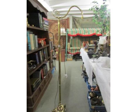 A heavy brass standard lamp.