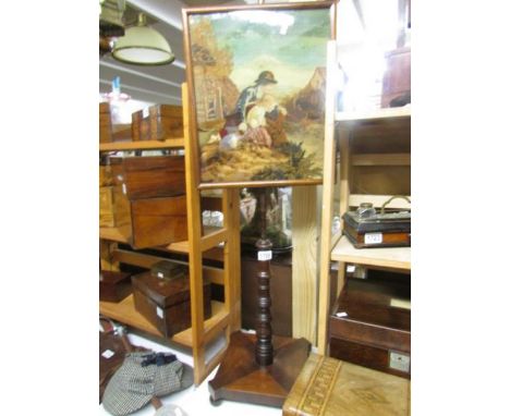 A Victorian mahogany pole screen with tapestry inset.