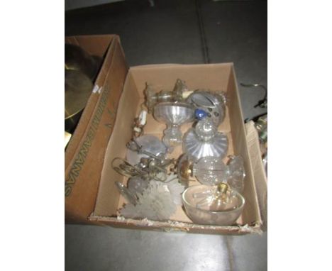 A box of assorted chandelier parts.