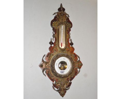 A barometer with embossed metal print.