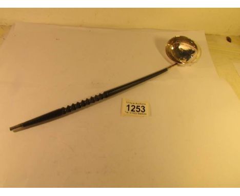 A late Victorian silver ladle with ebony handle.