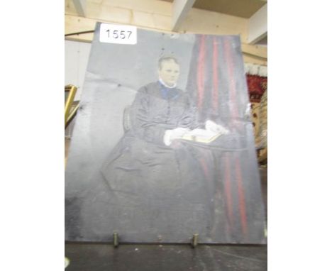 An old portrait of an elderly lady painted on tin.