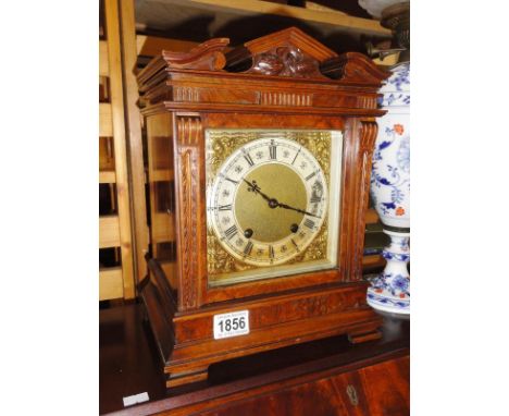 A wood cased architectural style mantel clock.