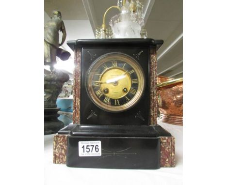 A black marble clock marked Usher & Son, Lincoln,.