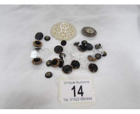 A quantity of old buttons including French female portrait button and a large carved button.