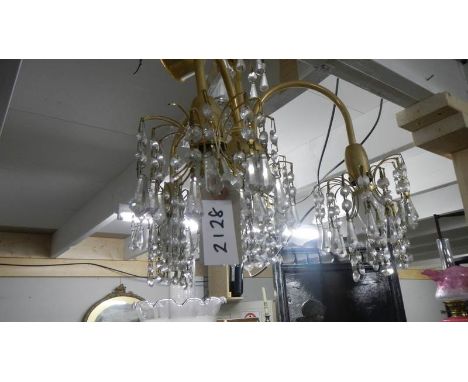 A 4 lamp glass and brass chandelier.