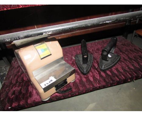 2 flat irons and a set of scales.