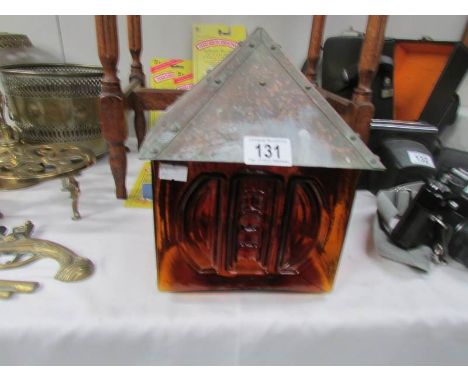 A Whitefriars style amber glass lamp shade with arts and crafts copper top.