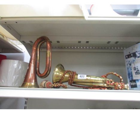 A brass bugle together with a brass and copper bugle with Royal Artillery badge, a/f,