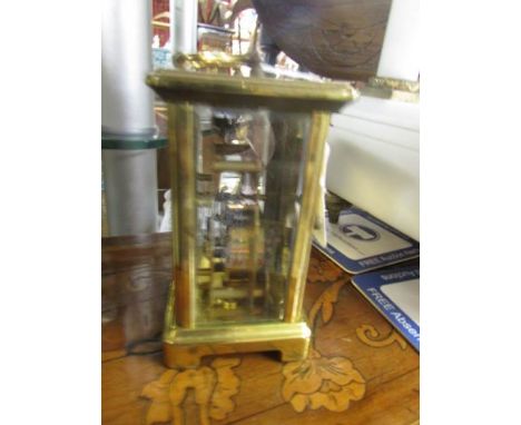 A brass carriage clock.