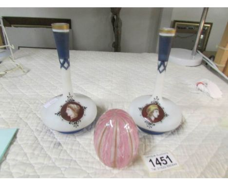 A pair of specimen bases with portrait cartouches and a glass egg.