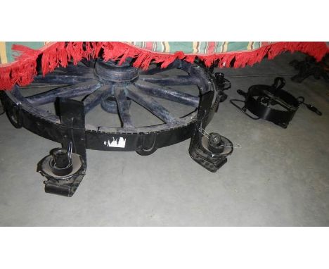 A large and heavy cart wheel chandelier.
