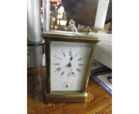 A brass carriage clock.