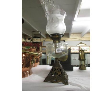 A Victorian oil lamp with later shade.