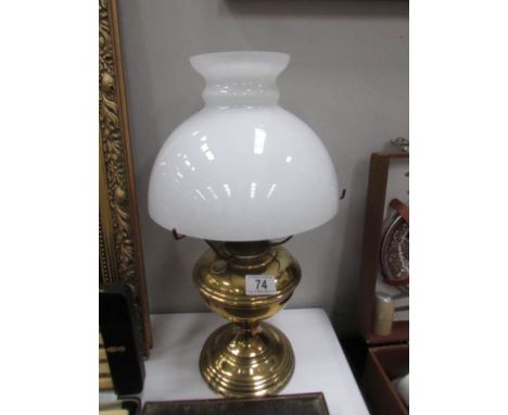 An Aladdin oil lamp, missing chimney.