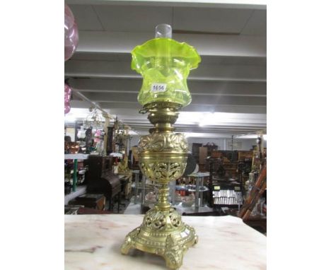 A Victorian bras soil lamp with yellow glass shade.