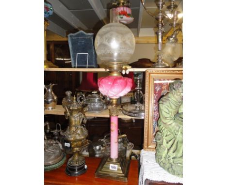A Victorian pink cranberry Corinthian column oil lamp.
