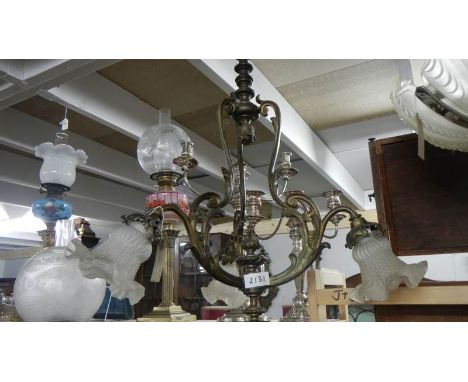 An antique 3 lamp brass ceiling light.